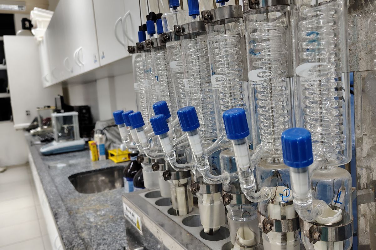 Glass condensers and laboratory glassware on a bench